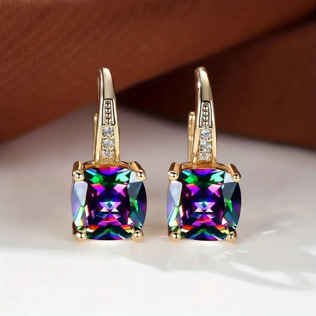 Claudine – Aros dorados con zafiro místico