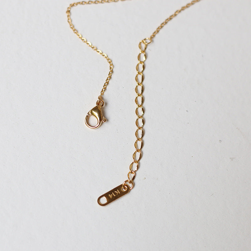 Nelly – Collar cruz minimalista en oro