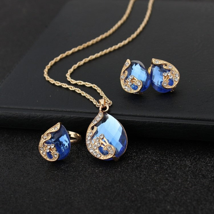 Pia – Conjunto de joyas con collar y pendientes de cristal azul y dorado