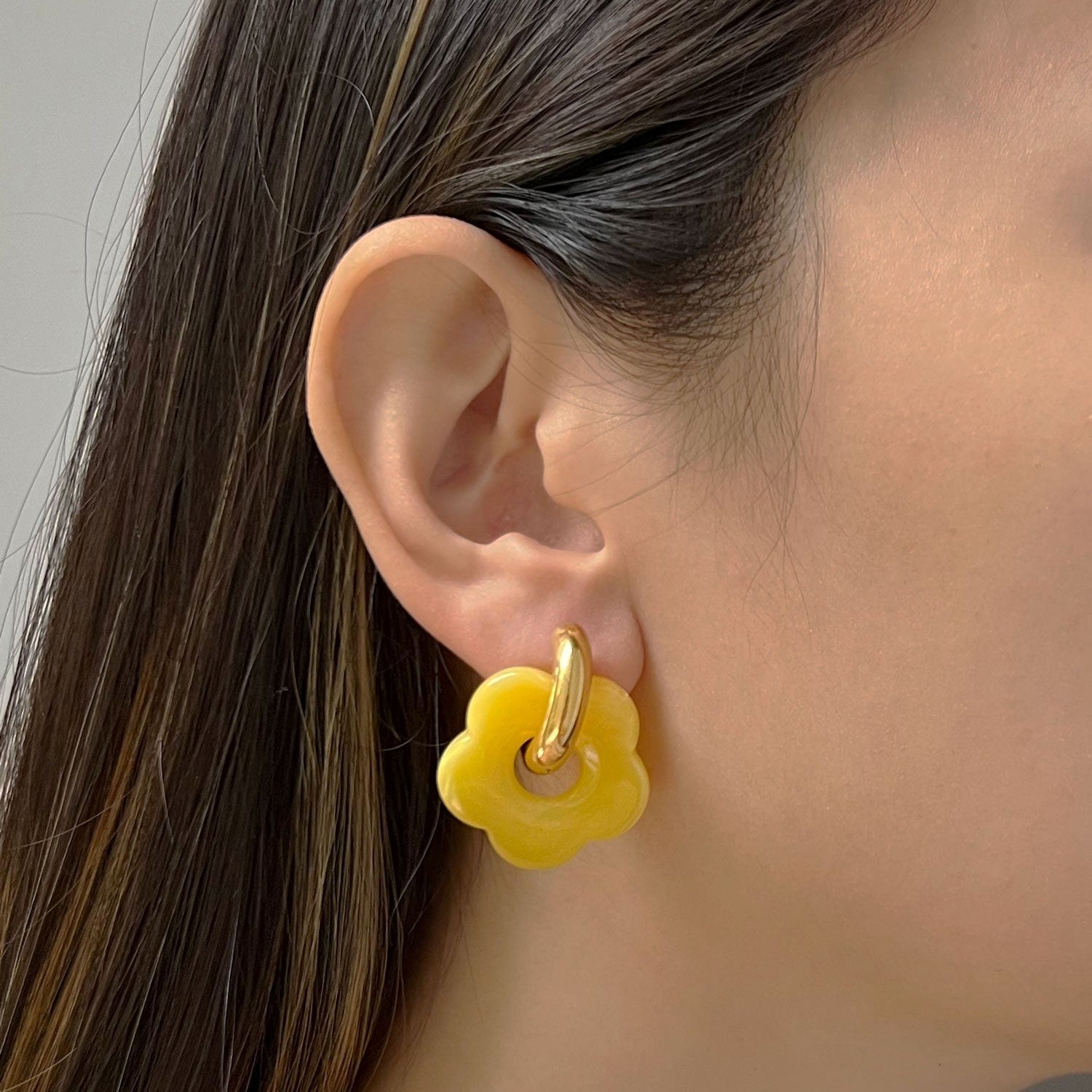 Aros de donut amarillos con colgante de flor