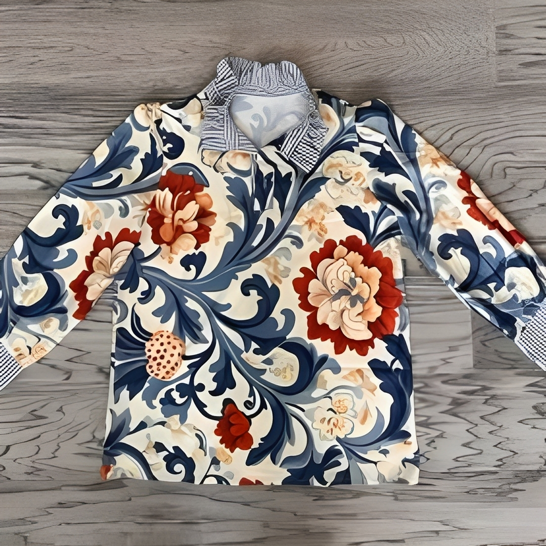 Blusa de mujer con abertura de botones a media altura, cuello tipo camisa y puños a rayas, estampado en todo el tejido, manga larga, corte relajado